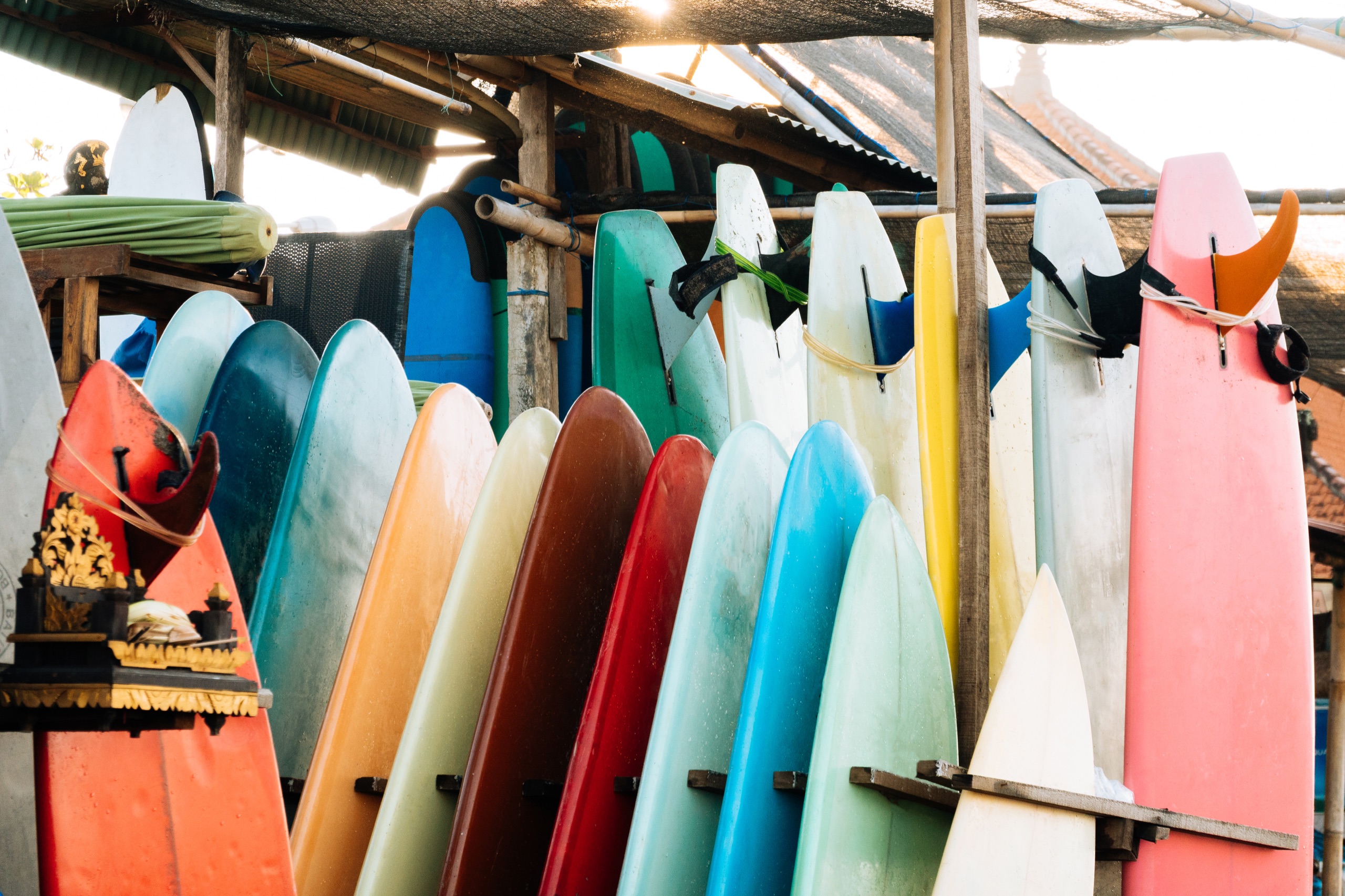 Colorful surfboards lined up in a rack